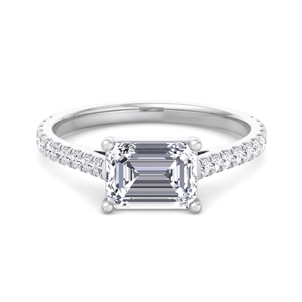 Costa east-to-west emerald cut engagement ring with tapered side stones in white gold