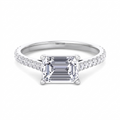 Costa east-to-west emerald cut engagement ring with tapered side stones in white gold