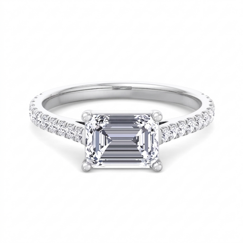 Costa east-to-west emerald cut engagement ring with tapered side stones in white gold