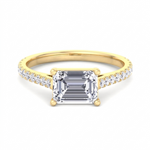 Costa engagement ring, emerald cut diamond set horizontally along the finger