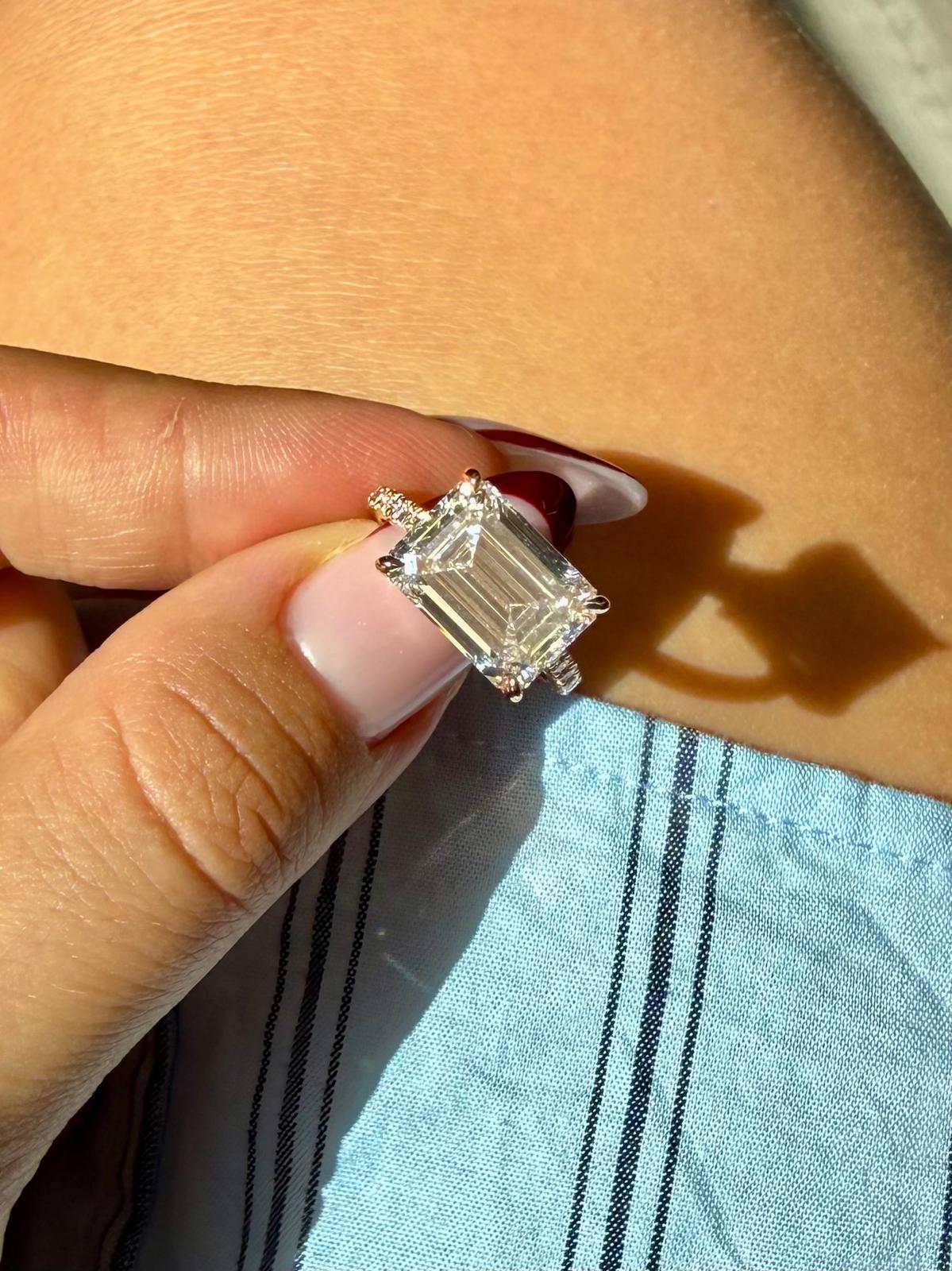 Costa engagement ring on the hand, showing scale of the 5ct emerald cut diamond