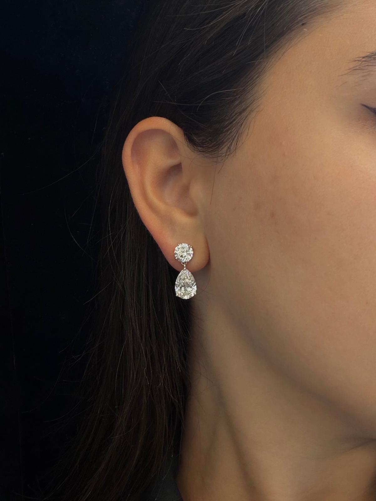 Marea diamond drop earrings worn, showing the movement of the pear-shaped stone