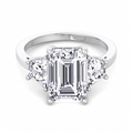 Vela three-stone engagement ring with emerald cut centre and trapezoid side stones